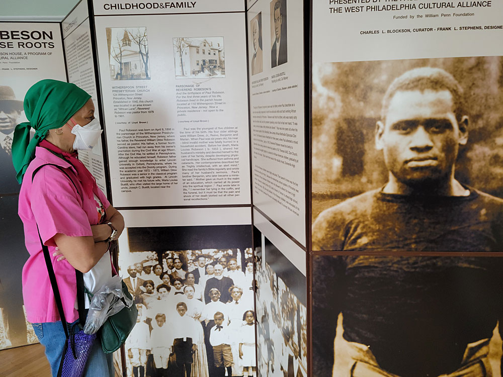 Visitor Charlotte Williams reads about Paul Robeson's early years.