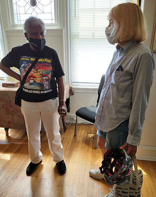 Docent Donna Samuel speaks to visitor Ann Fuchs about Robeson's life. 