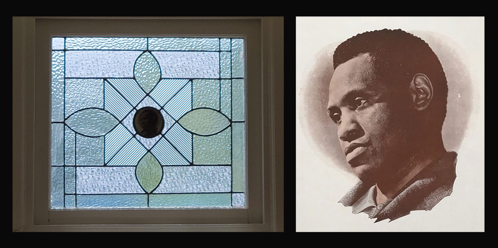 A stained glass window in a second-floor has a portrait of Robeson in the center.