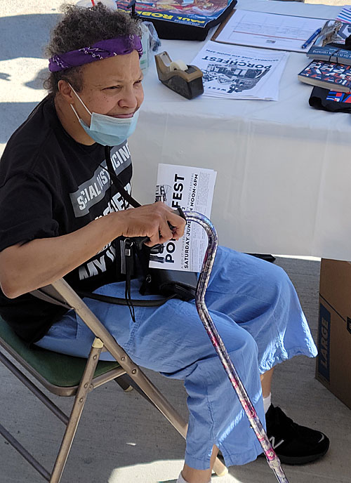 Lorraine Ric, volunteer and longtime supporter, basks in the cool shade and soaks up the music during Porchfest 2022 at the Paul Robeson House & Museum, June 4, 2022.