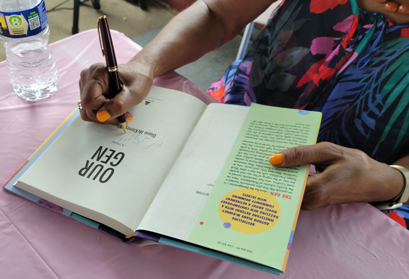 Diane McKinney-Whetstone signs a book up-close. Photo by Sherry L. Howard.