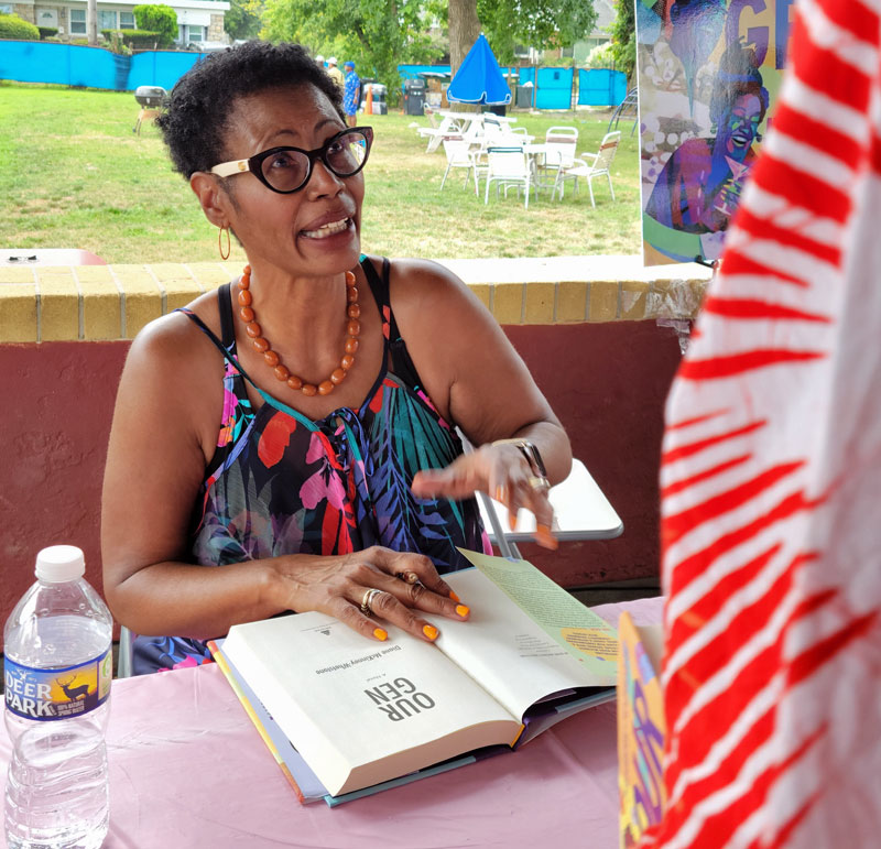 Diane McKinney Whetstone speaks to a fan before signing her book. Photo by Sherry L. Howard