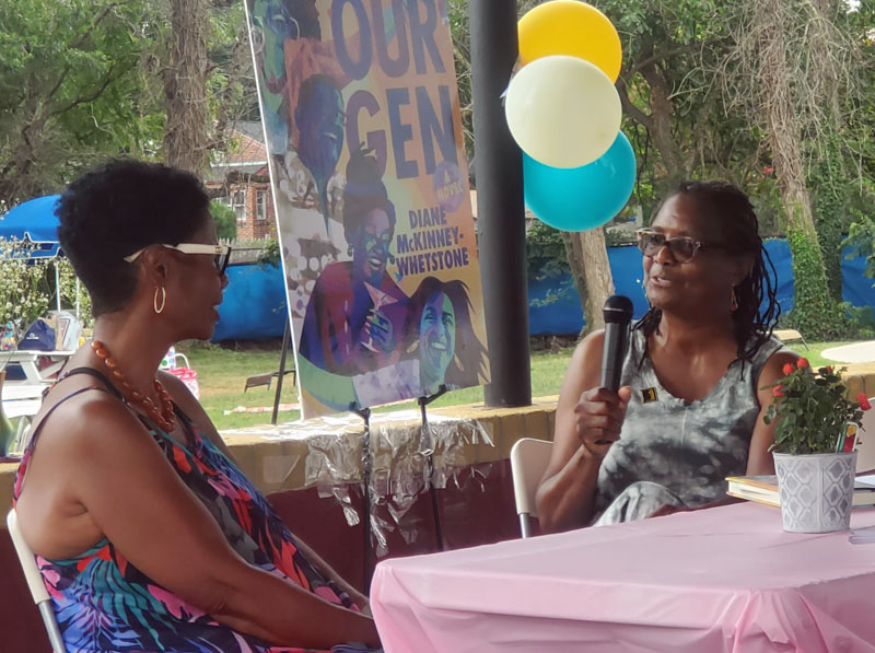 Sherry L. Howard, a volunteer at the Paul Robeson House & Museum, interviews author Diane McKinney-Whetstone about her book, "Our Gen." Photo by Kristin E. Holmes. 