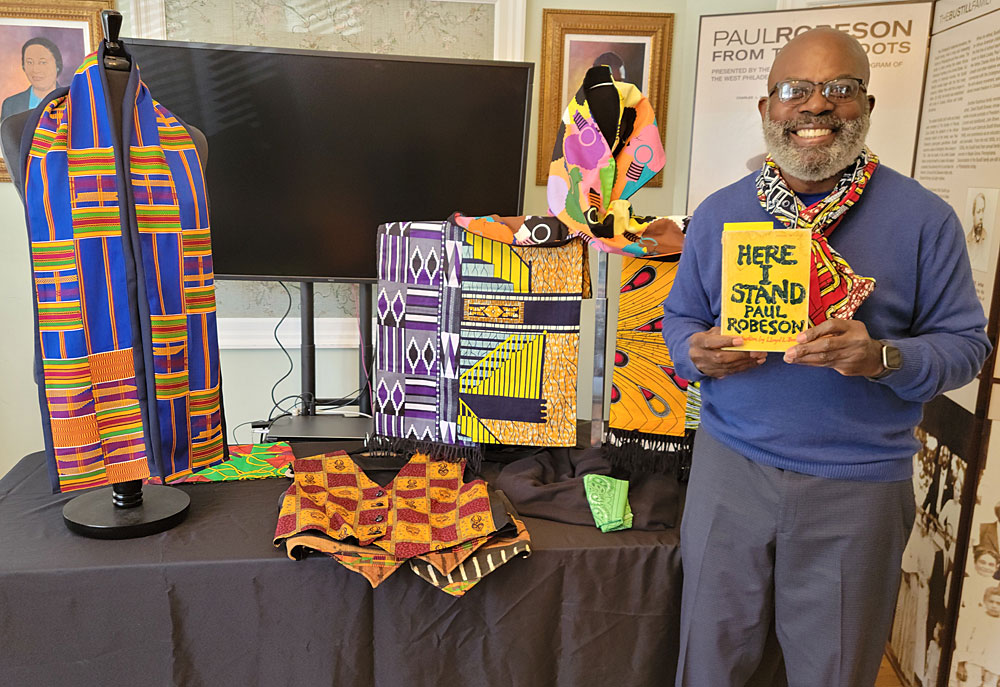 Roberto Rashid, of "Scarves by Rashid" displays his hand-crafted scarves and holds an autobiography written by Paul Robeson.