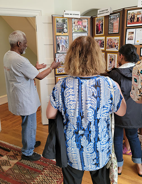 Docent David Merrill (left) introduces visitors to the new exhibit at the Paul Robeson House & Museum - a scrapbook of photos from our 125th Paul Robeson Birthday Celebration in April. Photo by Sherry L. Howard.