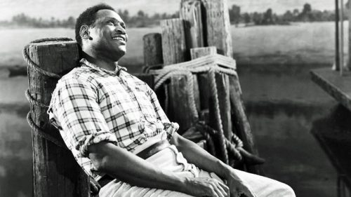 In this iconic photo from "Show Boat" in 1936, Paul Robeson sings his signature song "Ol' Man River." He later changed the original derogatory lyrics when he sang the song in concerts.